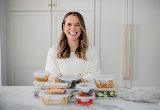 Brigid sitting in front of the lunch-boxes filled with food